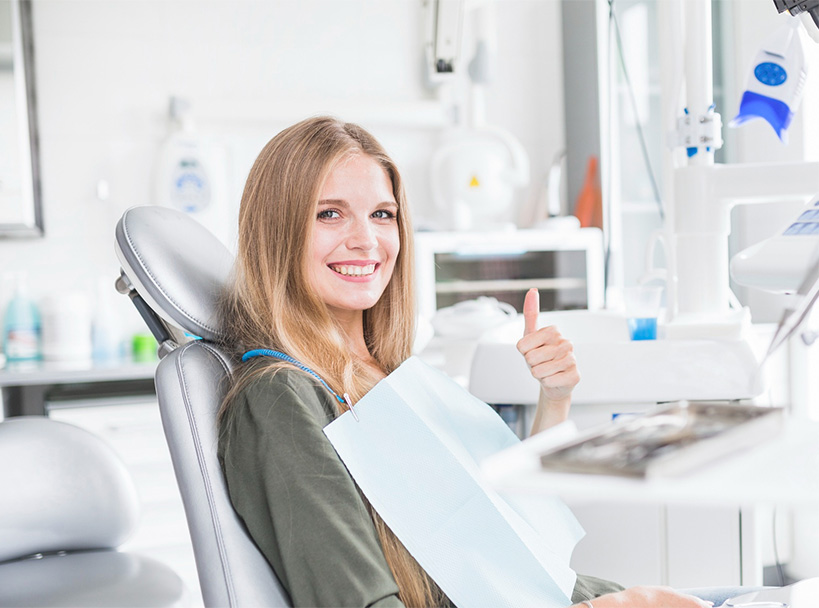 Girl Showing Thumbs Up After Dental Treatment